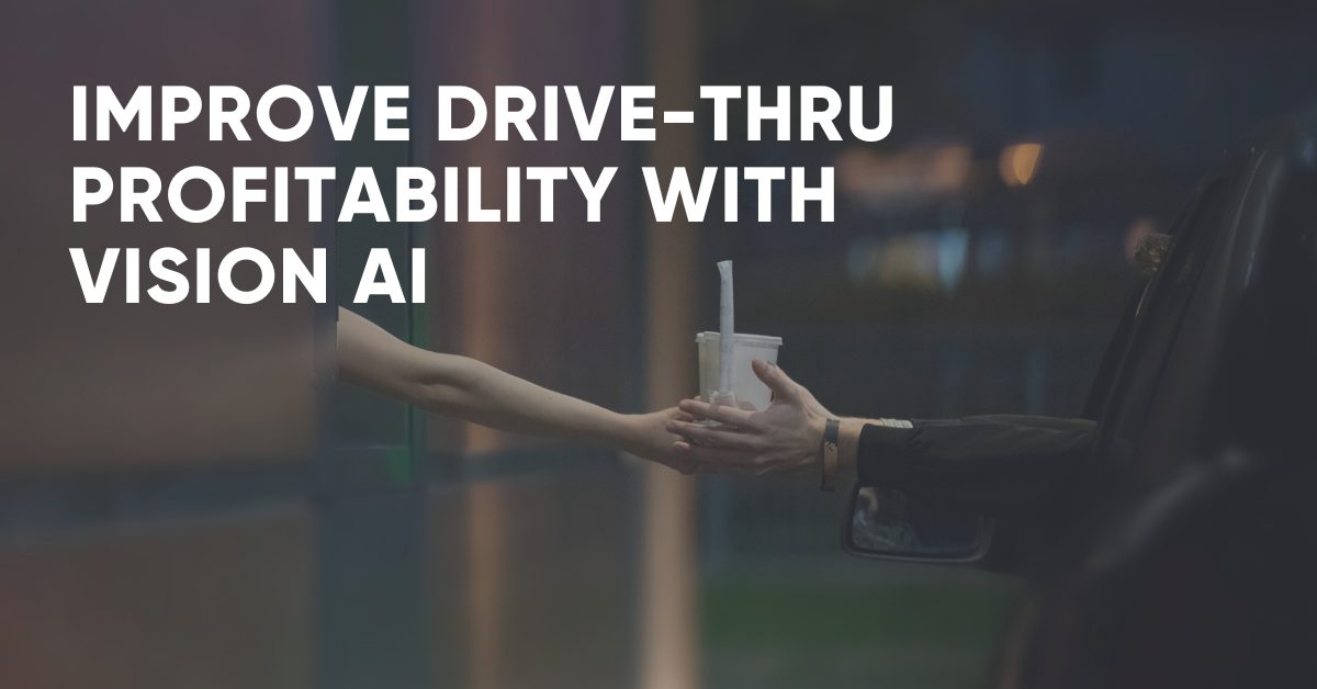 Image of a customer in a car receiving a beverage from a drive-thru window employee.