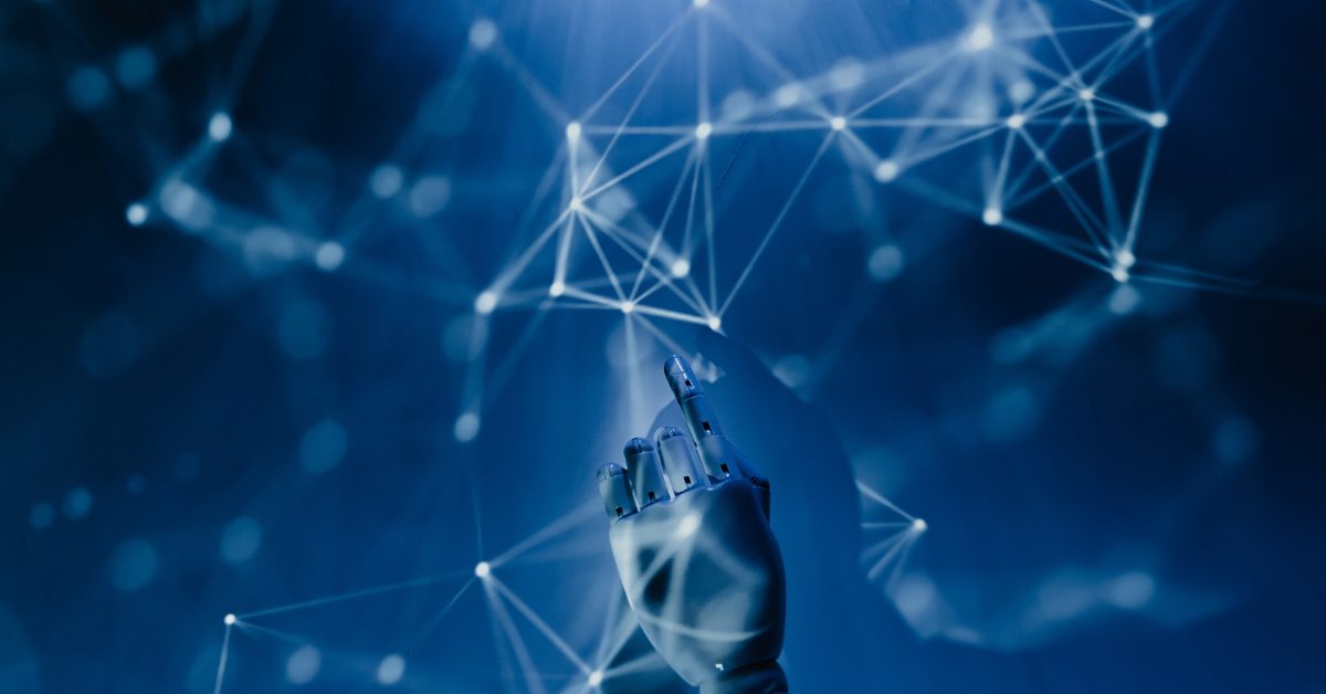 MVP Development Image of a plastic, robotic hand pointing towards data being used to develop a minimum viable product