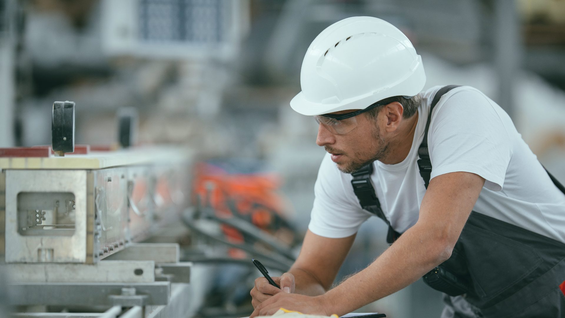 Manufacturing worker performing scheduled maintenance