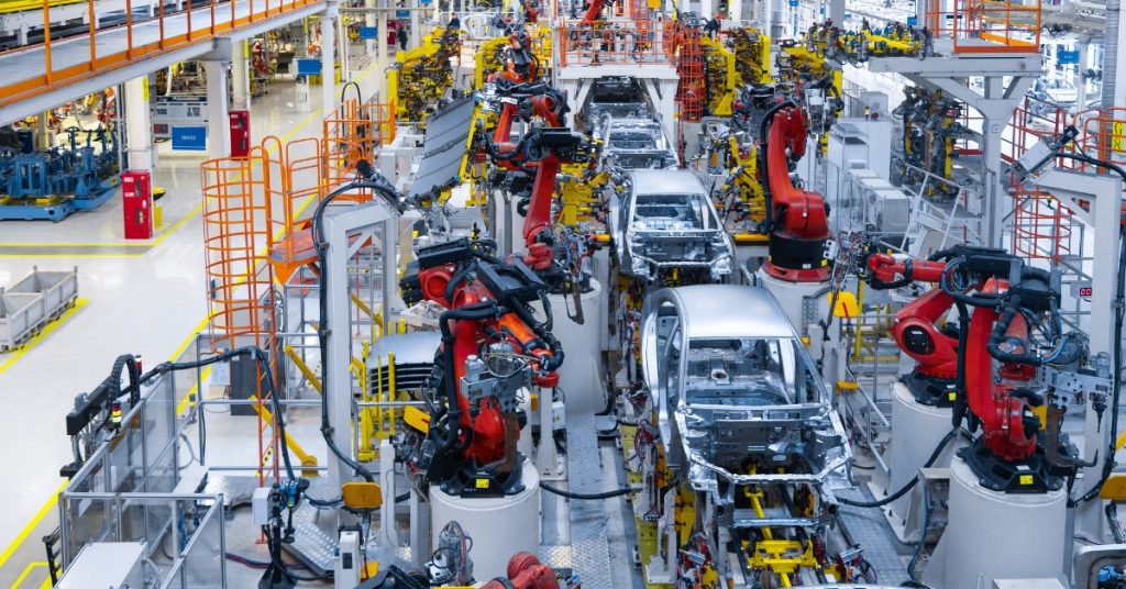 autos efficiently moving along assembly line