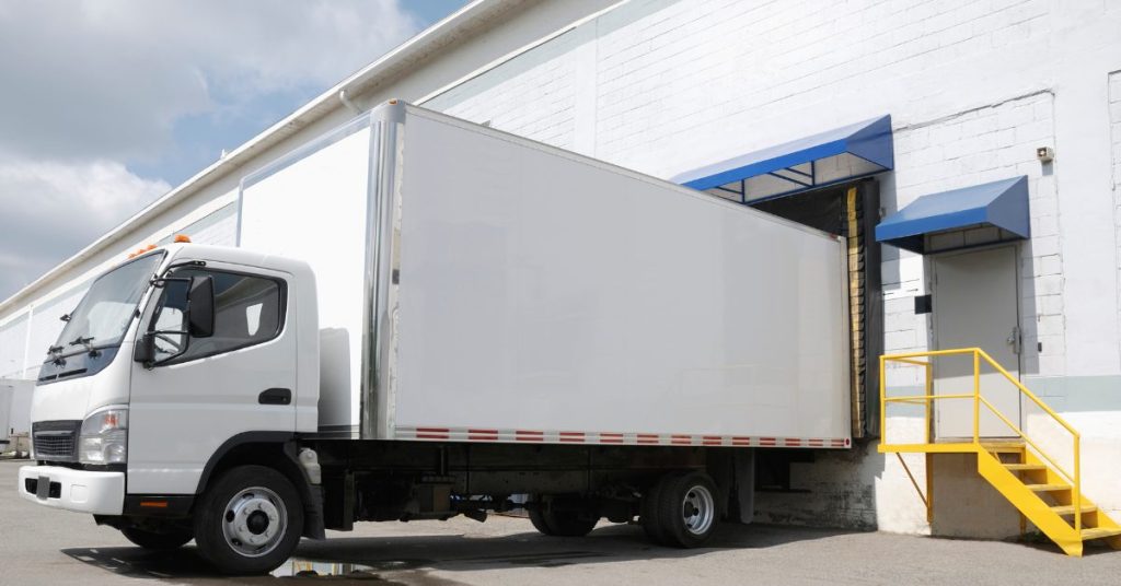 Image of a delivery truck unloading onto a receiving dock