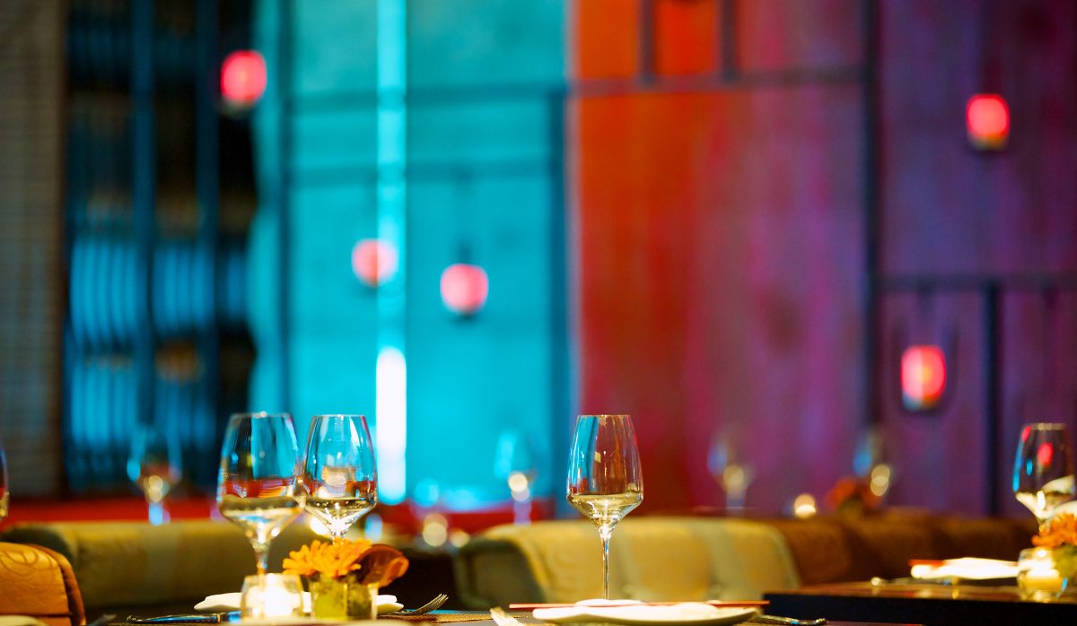 Dinner Invite Empty dinner table in an upscale restaurant, set with full wine glasses